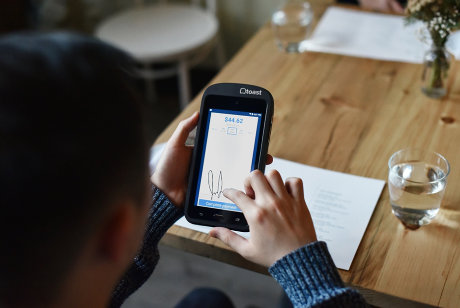 man paying at restaurant table