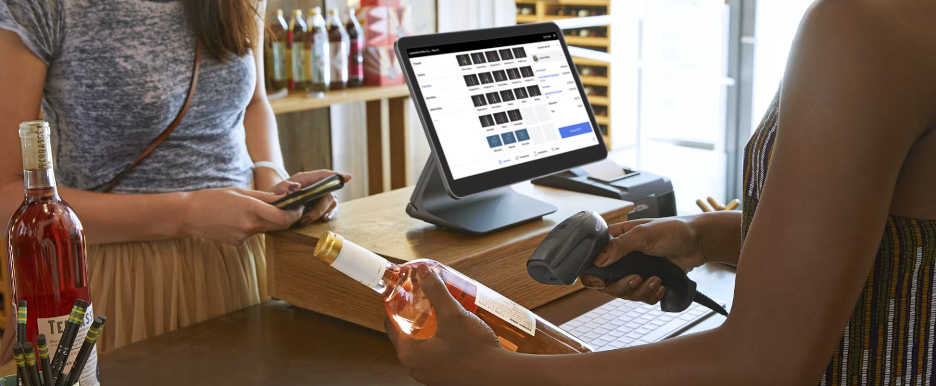 Person checking out at a register with a Square POS system