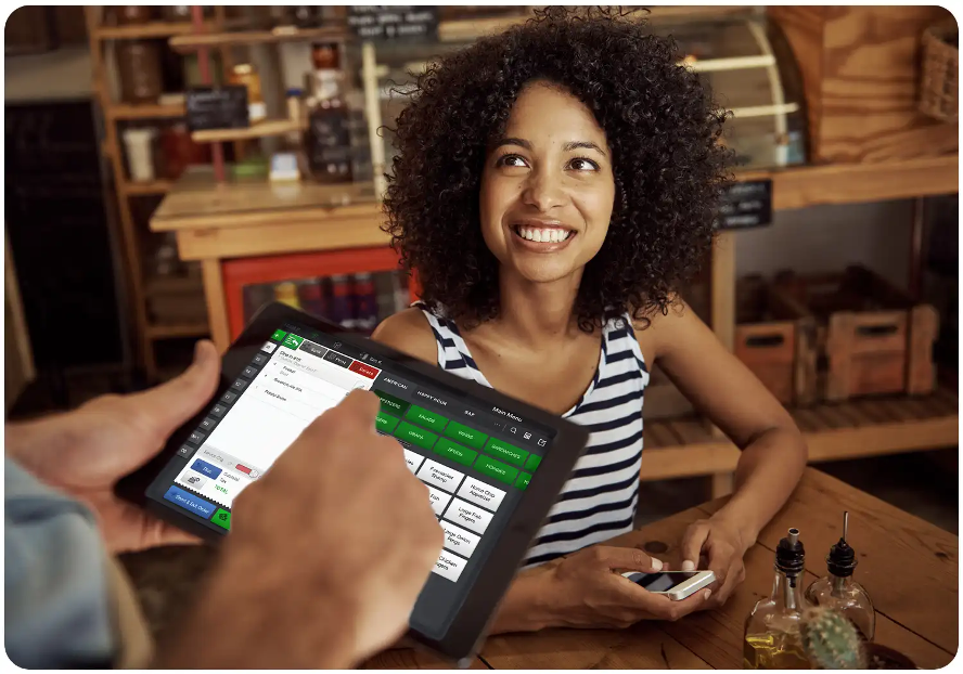 woman paying at a restaurant table